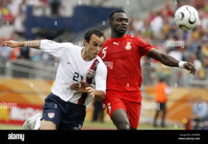 John Mensah of Ghana (R) fights for the ball with Landon Donovan of USA during the group E preliminary round match of the 2006 FIFA World Cup between Ghana and USA in Nuremberg, Germany.